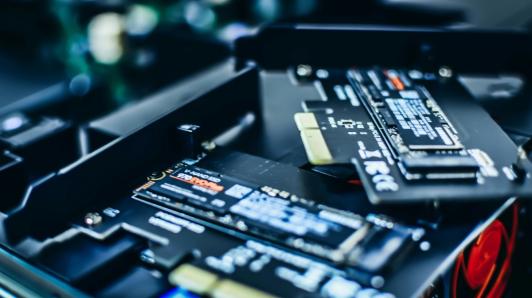 Two NVMe NAND SSD sticks, one sitting on top of the other.